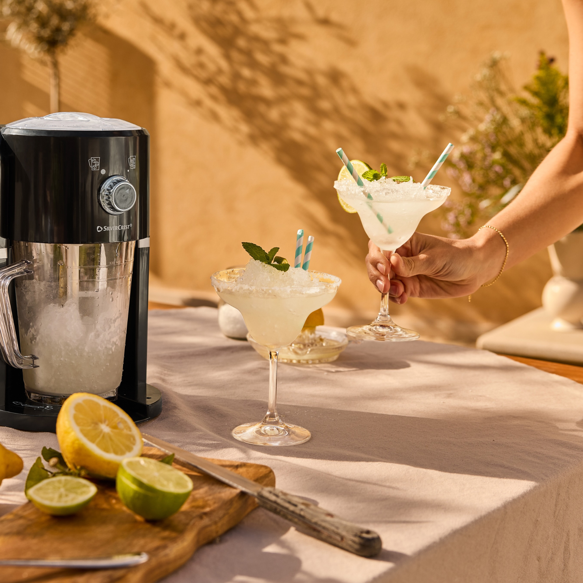 Lidl slushy maker next to frozen marg on outdoor table.