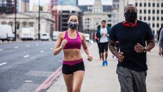 Road runners exercising in Central London wearing face masks