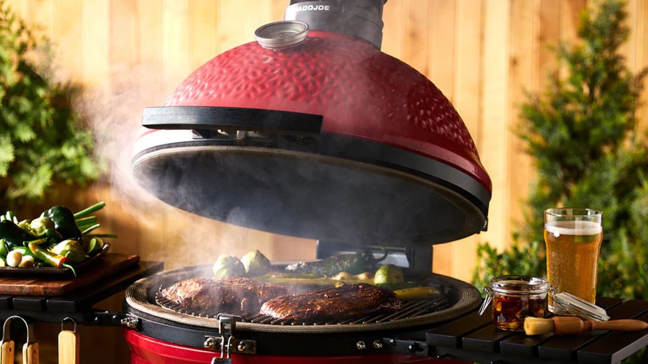 A Kamado Joe Classic Joe II grill cooking steak and vegetables