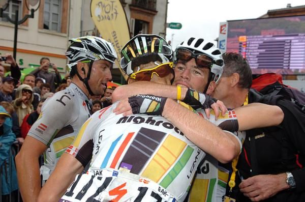 Mark Cavendish is congratulated by his HTC-Highroad teammates Bernhard Eisel and Lars Bak.