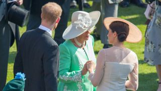rince Harry, Duke of Sussex, Camilla, Duchess of Cornwall and Meghan, Duchess of Sussex attend The Prince of Wales' 70th Birthday Patronage Celebration held at Buckingham Palace on May 22, 2018 in London, England.