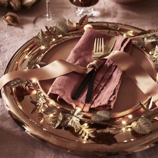 Christmas place setting, gold, bronze and terracotta with metal leaf fairy lights