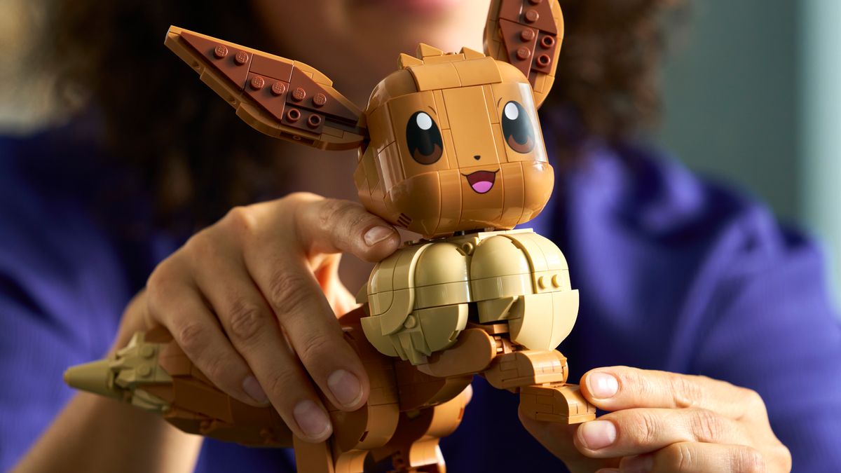 Lego Eevee being posed by hands