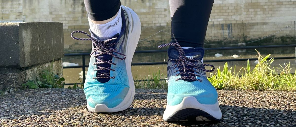 Woman&#039;s feet wearing Saucony Endorphin Shift 3 road running shoes - front view