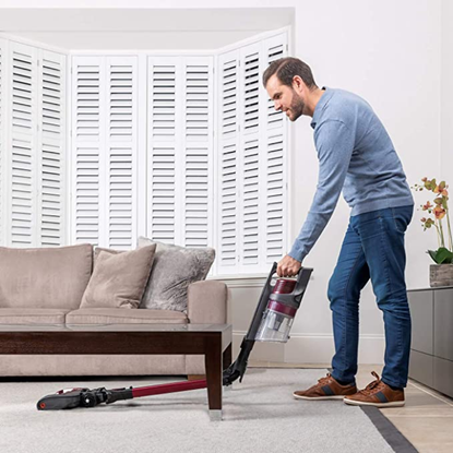 Man vacuuming the carpet 