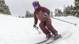 Woman skiing while wearing Glade Adapt 2 ski goggle