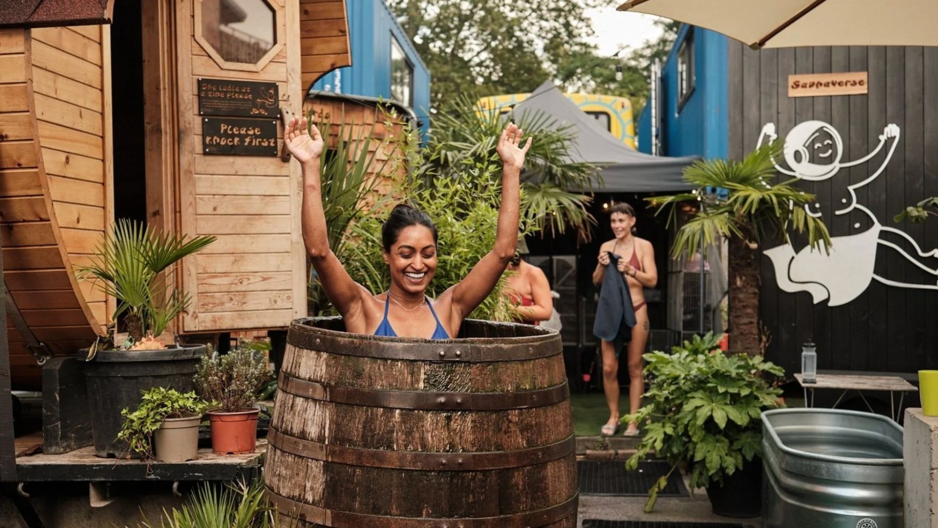 an image of a woman in the cold water plunge after exiting the sauna at the community sauna baths