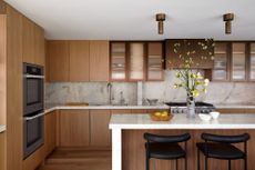 timber kitchen with marble countertop and metal upper cabinets