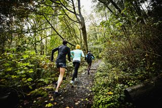 three runners on the trails