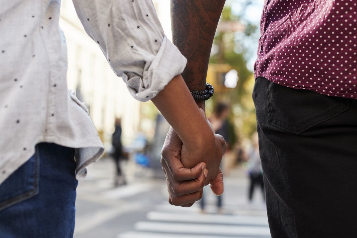 A couple holding hands.