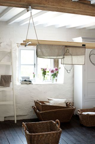 old cottage laundry room with traditional washing airer hanging from ceiling