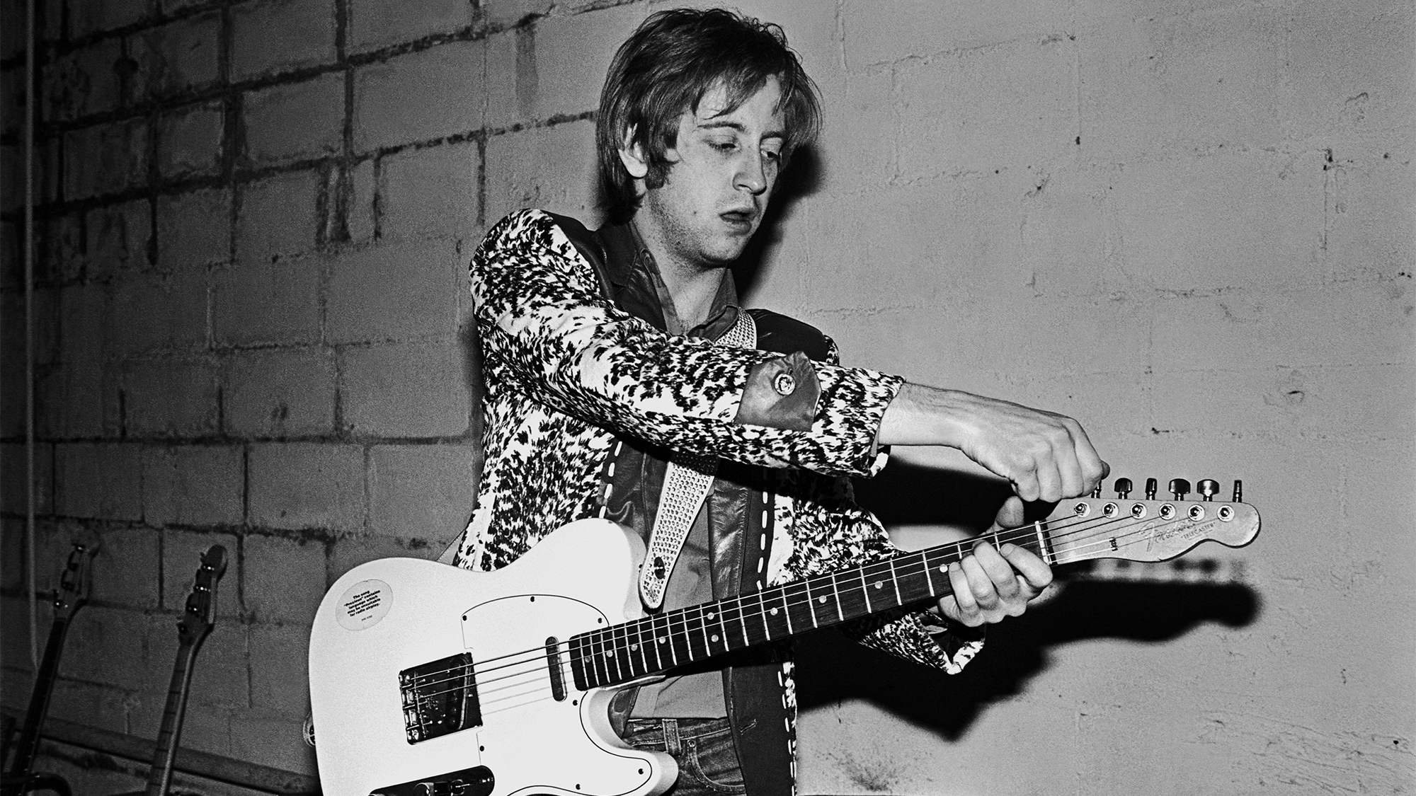 James Honeyman-Scott, lead guitarist with the British rock band The Pretenders, tunes his guitar before their first American concert tour stop in 1980 in Nashville, Tennessee.