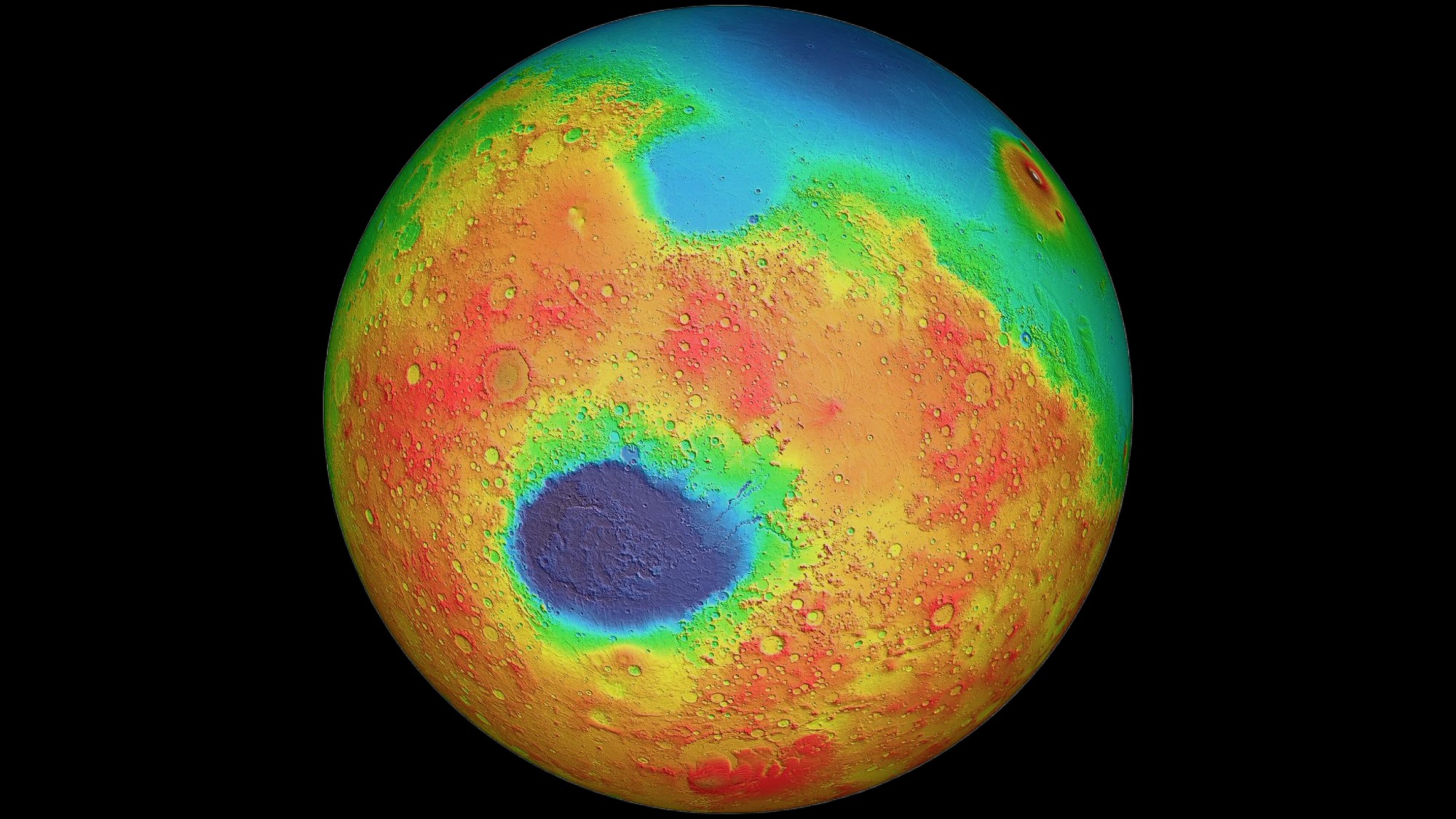 a blue, green, yellow and red orb on a black background. there is a large, dark depression on the southern half of the orb