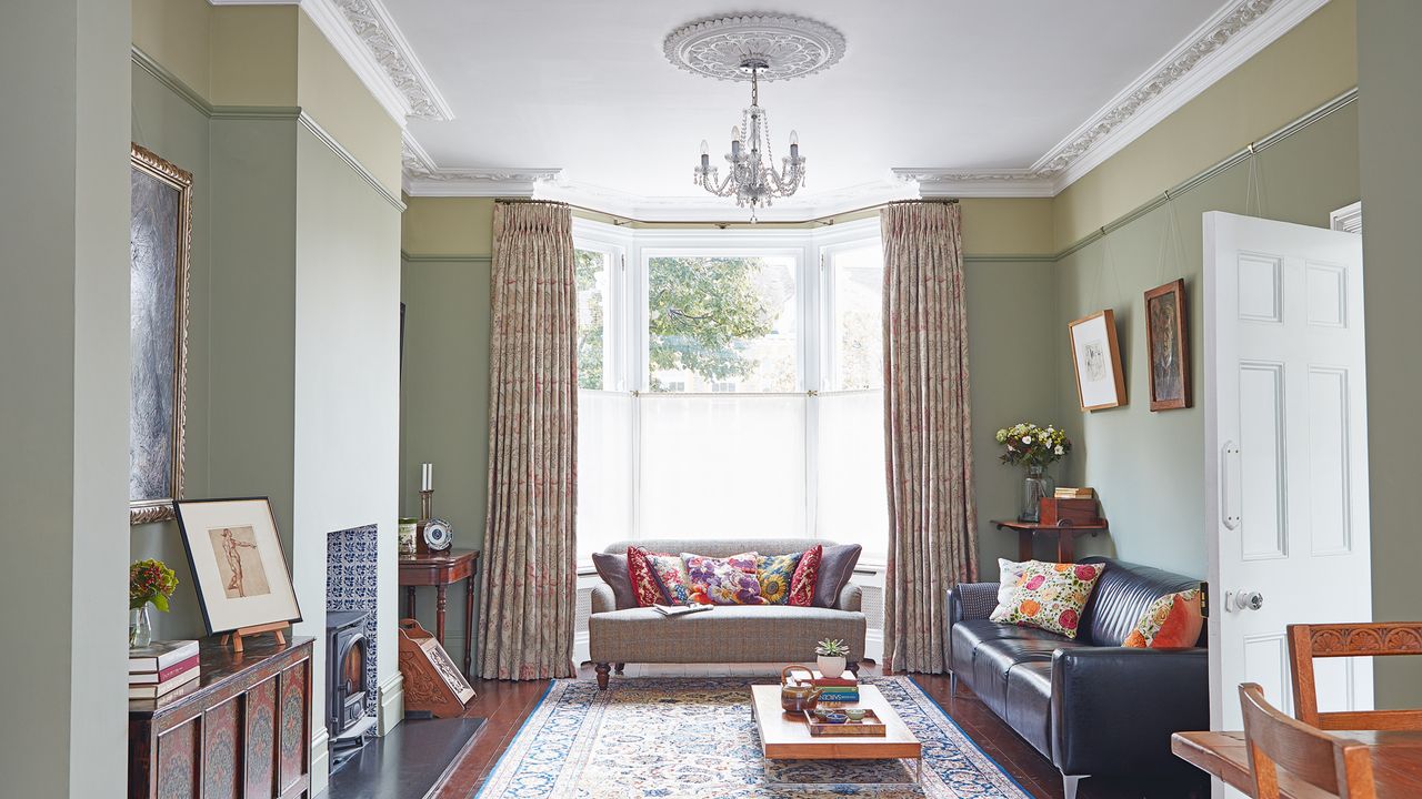 victorian living room with sofas, rug and fireplace