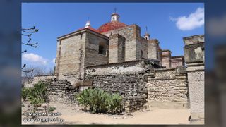 We see a stone church in a desert setting. 