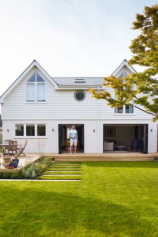 white house with landscaped back garden with decking