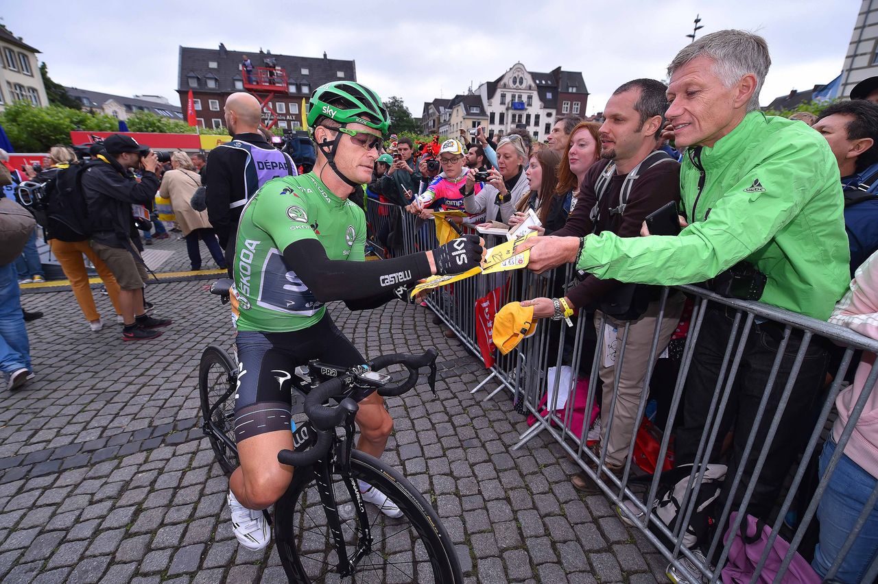 Vasil Kiryienka greets fans at the start of stage 2 of the Tour de France.