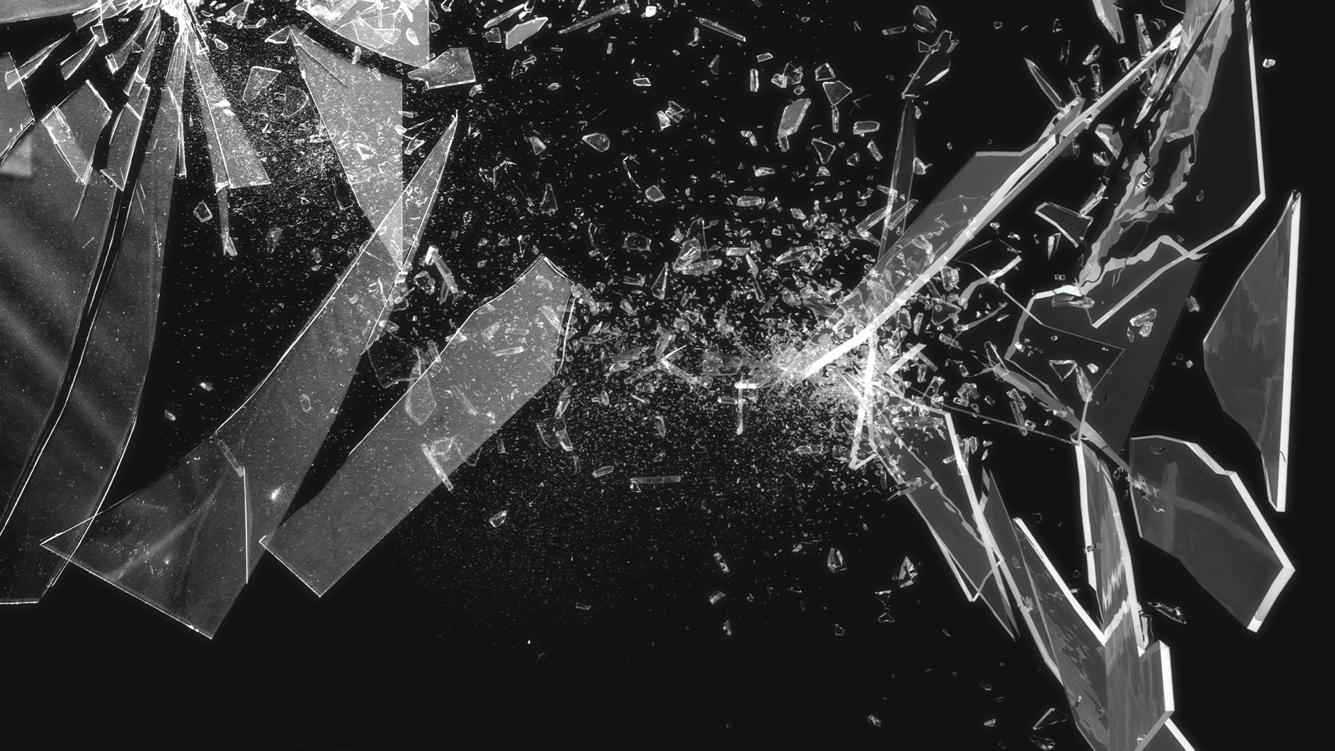 Shattered glass fragmenting into a multitude of sharp splinters pictured against a black backdrop.