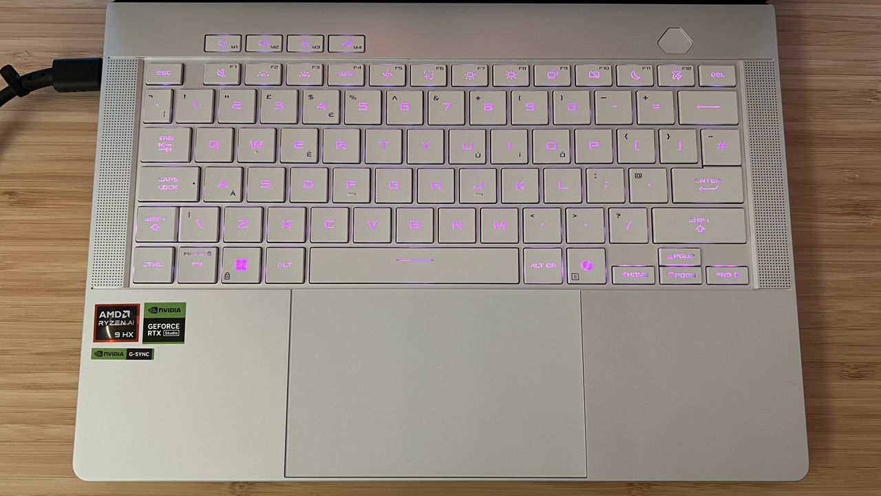 Keyboard and trackpad of Asus ROG Zephyrus G14 gaming laptop with pink RGB lighting