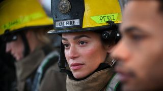 A close up of Stephanie Arcila in a fire helment in Fire Country.