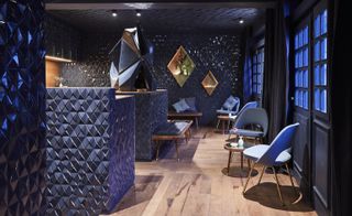 Bonechina interior with wooden flooring dark blue wall panelling and blue diamond cut ceramic tiles