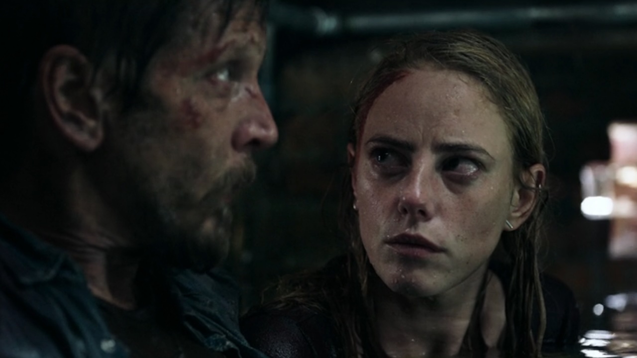 Barry Pepper and Kaya Scodelario looking tired and scared in Crawl