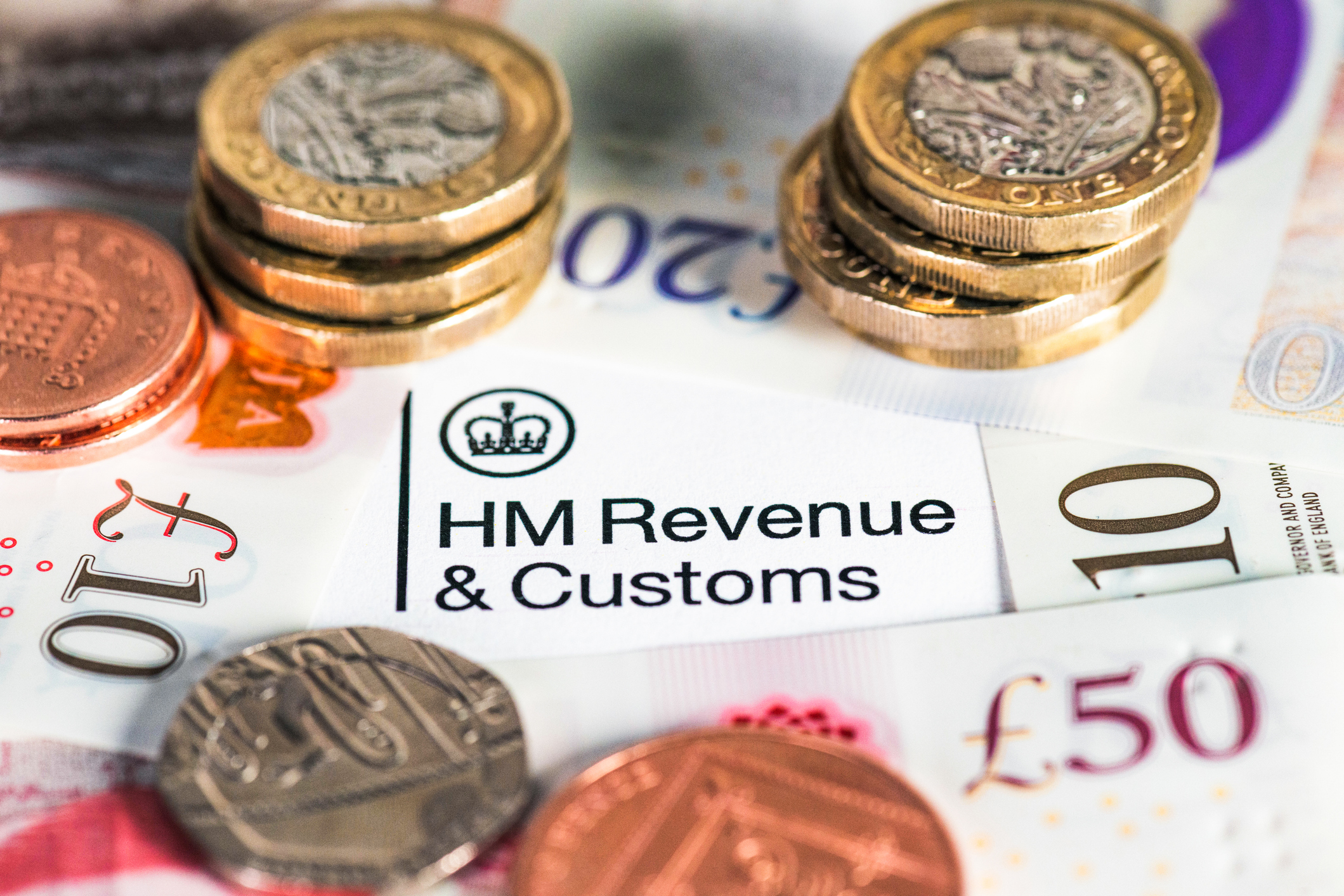 Money surrounding HMRC logo
