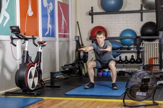 Image shows a person working out at the gym for cycling benefits