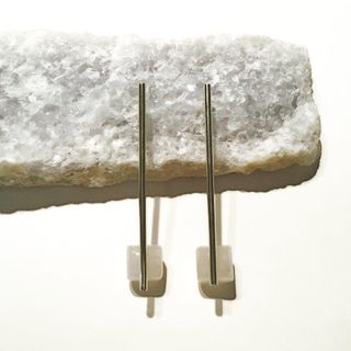 two pieces of jewellery resting on rock