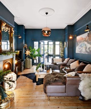 Beautiful dark blue living room with leather sofa and luxurious fixtures and fittings