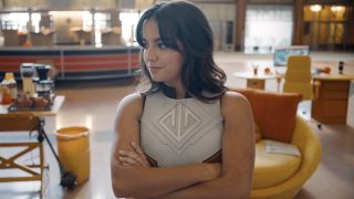 Isabela Merced smirking as unmasked Hawkgirl in Justice Gang headquarters