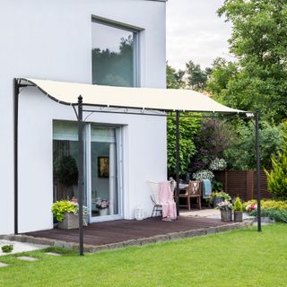 Small cream colored gazebo with steel legs covers patio space