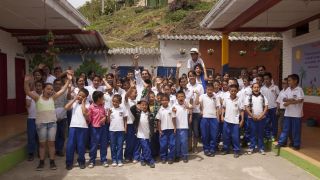 Children standing outside of a school in Latin America