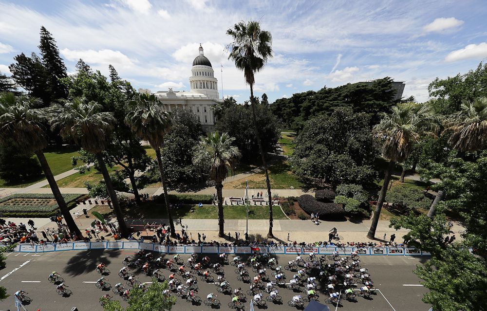 The peloton passes the state capitol during the final stage at the Tour of California