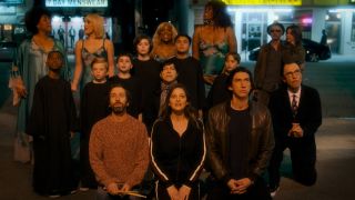 Simon Helberg, Marion Cotillard, Adam Driver, and Sparks kneel with the cast of Annette.