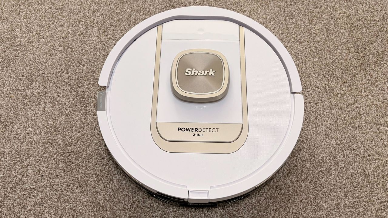 Shark PowerDetect 2-in-1 ThermaCharged NeverTouch photographed on a carpet with docking station