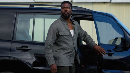 Yahya Abdul-Mateen II as John Creasy gets out of a car in a scene from Netflix's "Man on Fire"