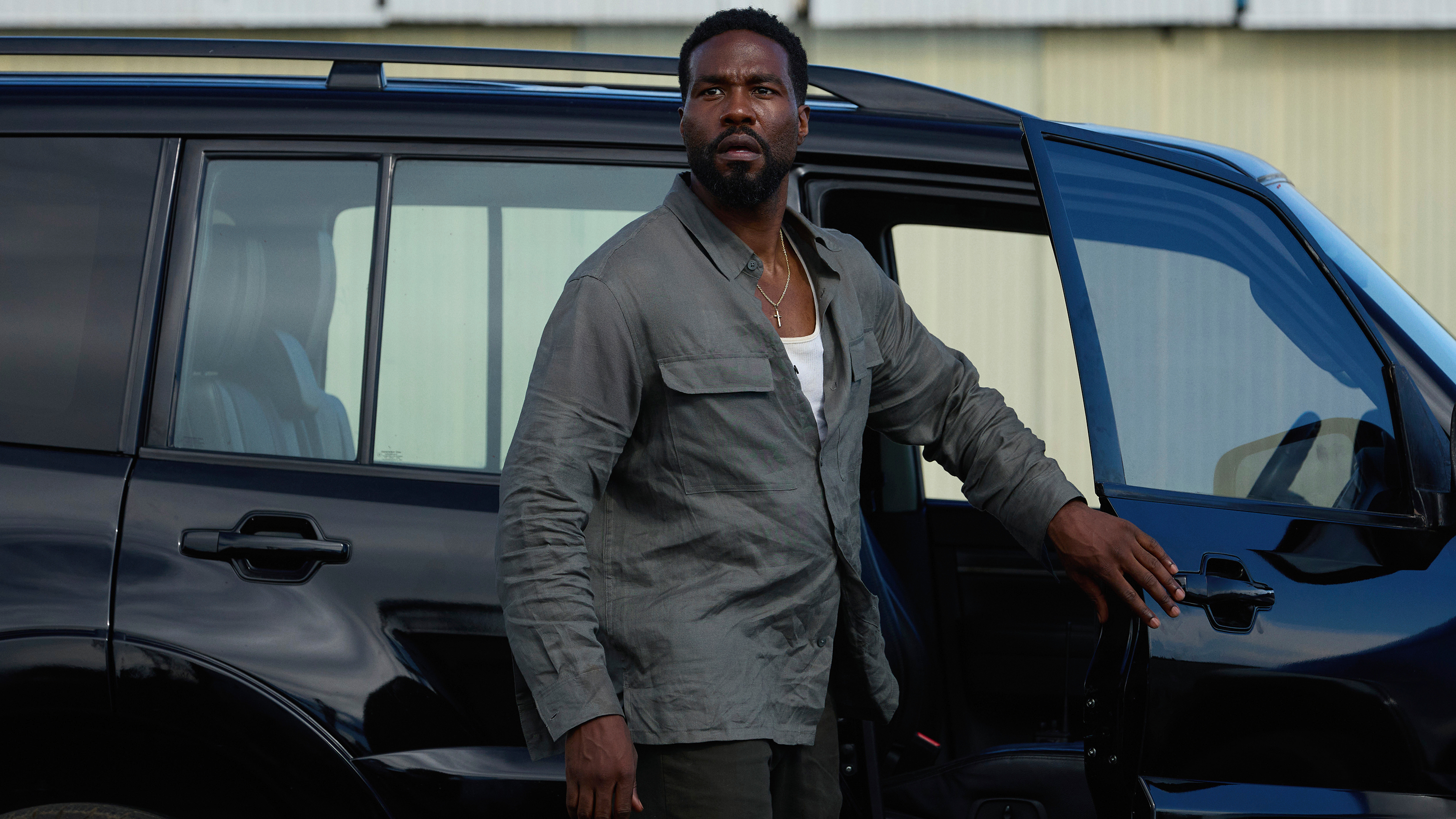 Yahya Abdul-Mateen II as John Creasy gets out of a car in a scene from Netflix's "Man on Fire"