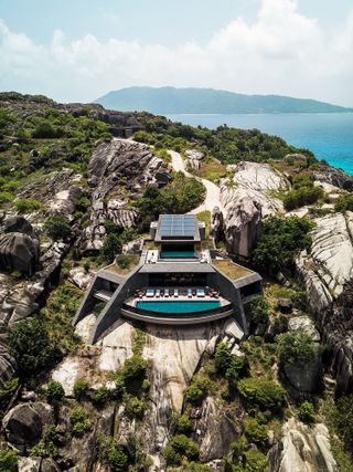 Aerial view of residence situated on rocks