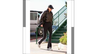 Kendall Jenner seen wearing a cap, sunglasses, black leggings and a brown leather jacket