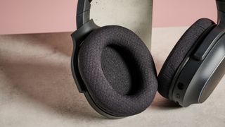 Close-up of ear pad on Razer Barracuda X Chroma on table resting on plinth