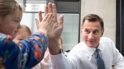 Jeremy Hunt high-fives child