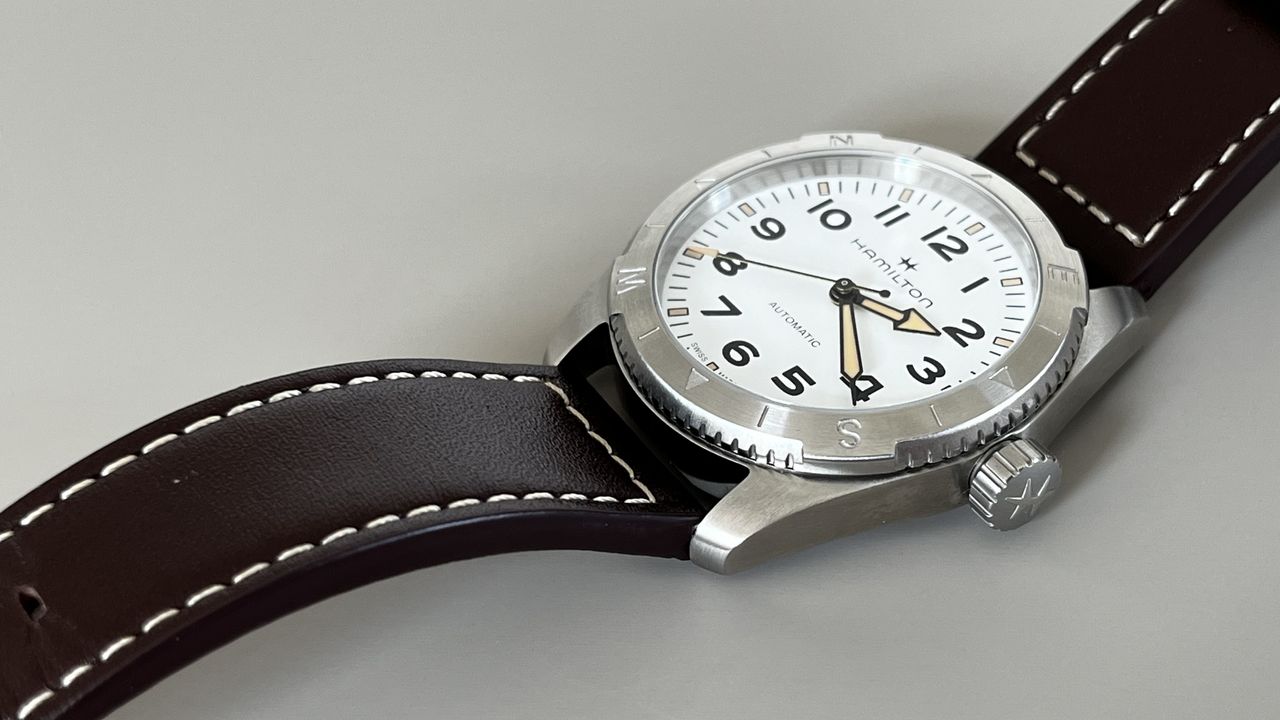 The Hamilton Khaki Field Expedition with a white dial on a grey background