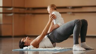 a photo of a woman exercising with her baby