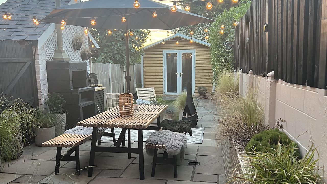 outdoor garden with dining table and bench and parasol