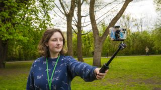 Person using Neewer TP38 as a phone selfie stick 