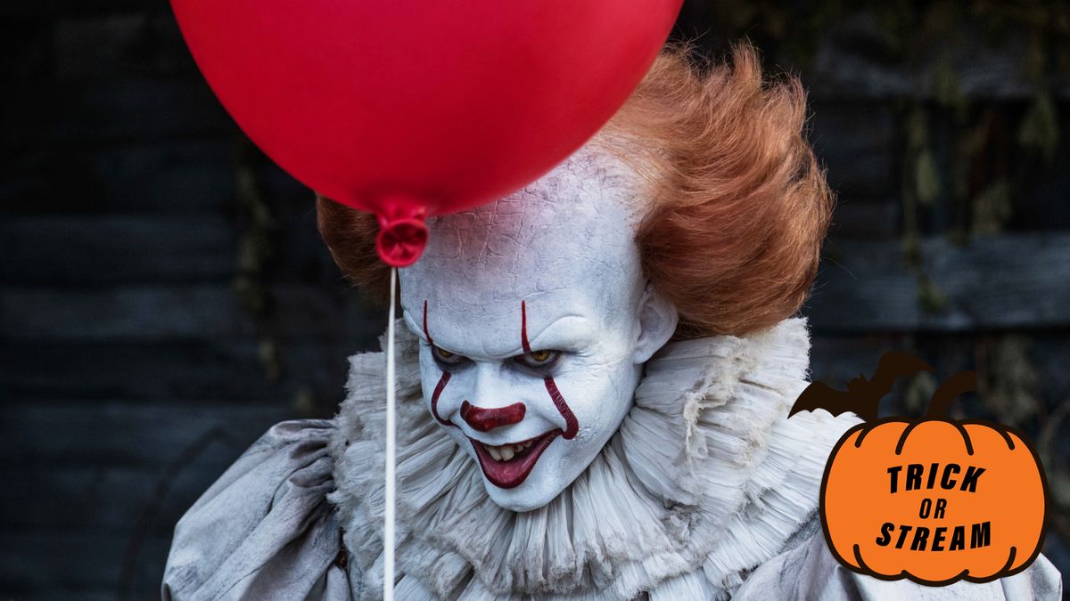 Bill Skarsgård as Pennywise holding a red balloon and smiling in &quot;IT&quot; (2017)