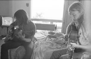 Dickey Betts (left) and Duane Allman play acoustic guitars in a hotel room before the Allman Brothers Band's performance at the Sitar in Spartanburg, South Carolina on October 17, 1970