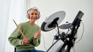 A lady learning how to play the drums