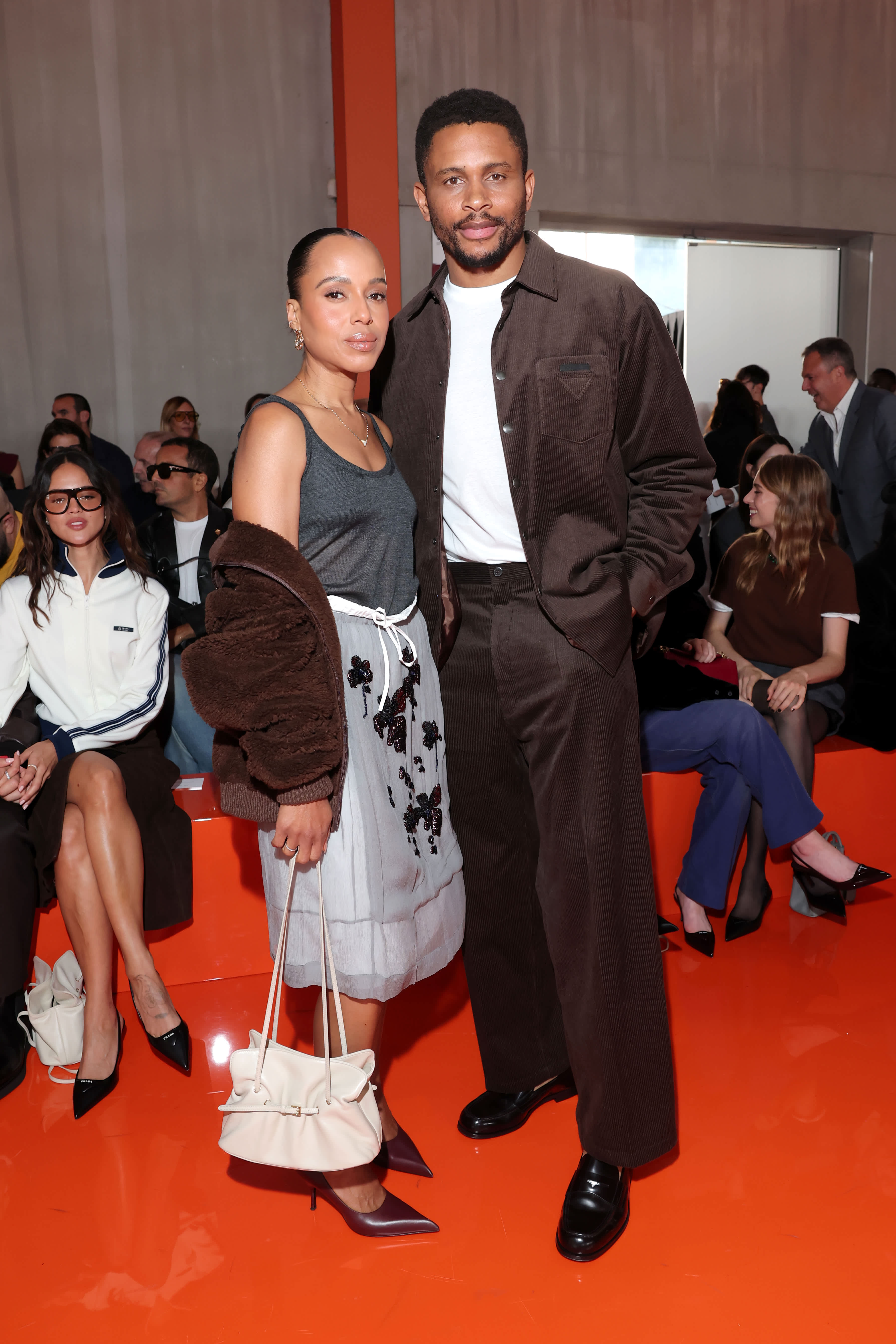 Kerry Washington and Nnamdi Asomugha sitting front row at Prada's SS26 show.